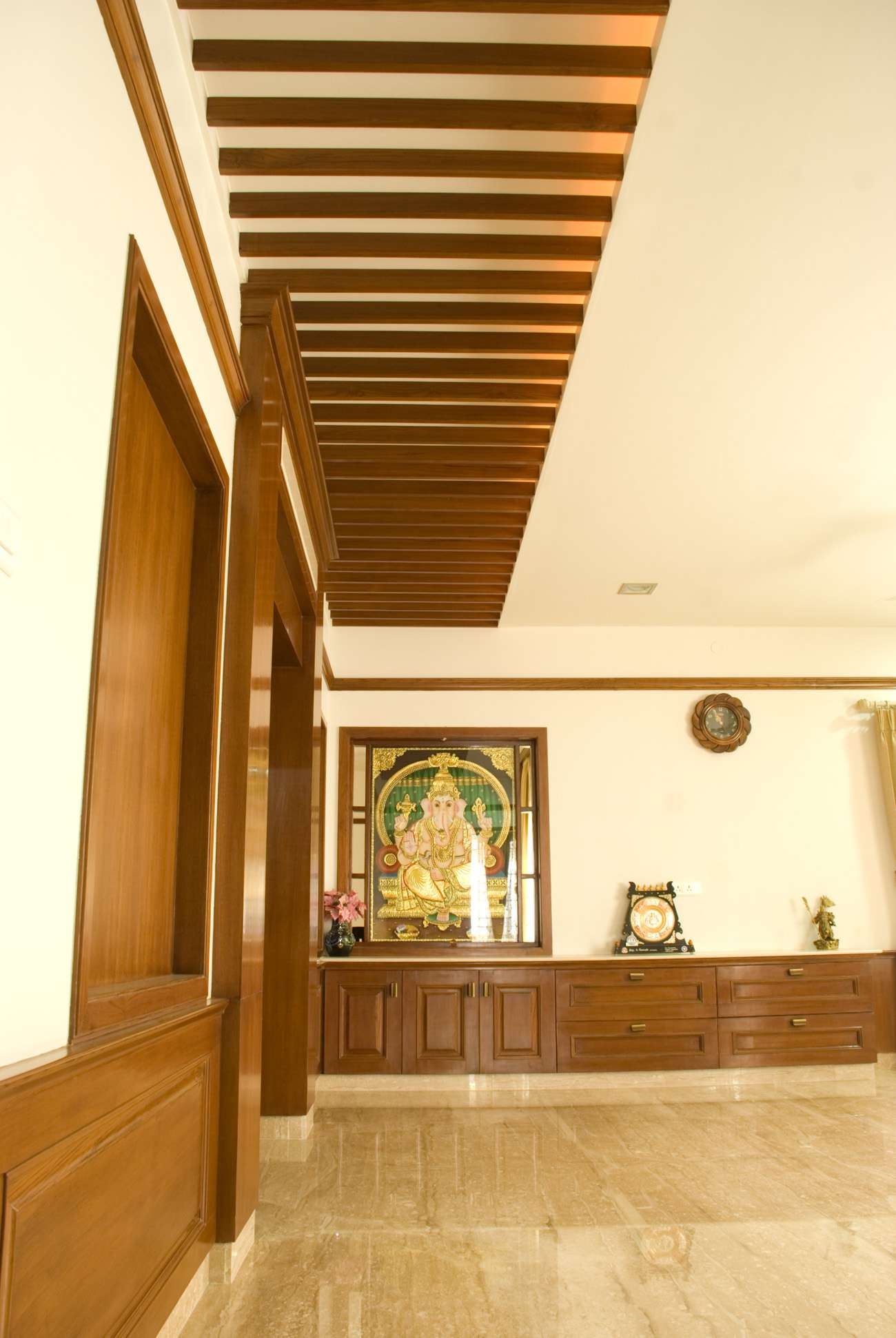 Elegant wooden ceiling rafters and traditional wood paneling in a premium interior project by our team in Coimbatore – custom-designed by expert interior designers and contractors