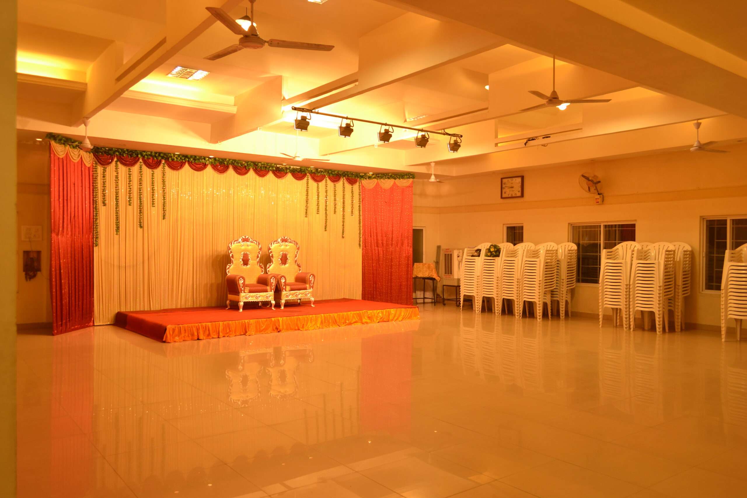 Traditional wedding hall interiors, with warm ambient lighting – Interior design solution by expert carpentry and interior teams in Coimbatore, India.