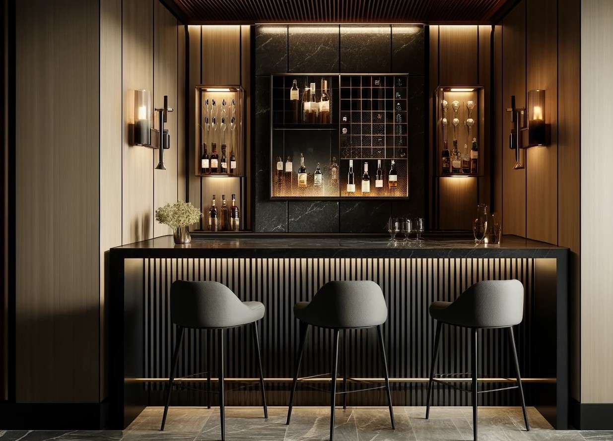 Modern luxury bar counter with vertical slat detailing, dark stone finishes, and ambient lighting, custom-designed and installed by our interior team at a private dining restaurant in Tamil Nadu.