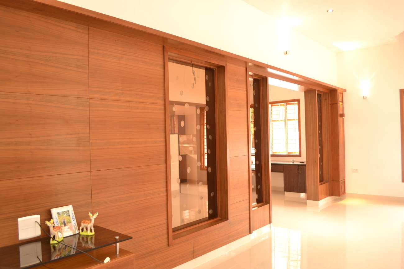 Sleek wooden wall paneling with glass inlays and clean-lined finishes, Designed, manufactured and executed by our interior team at a residential project in Coimbatore, Tamil Nadu.