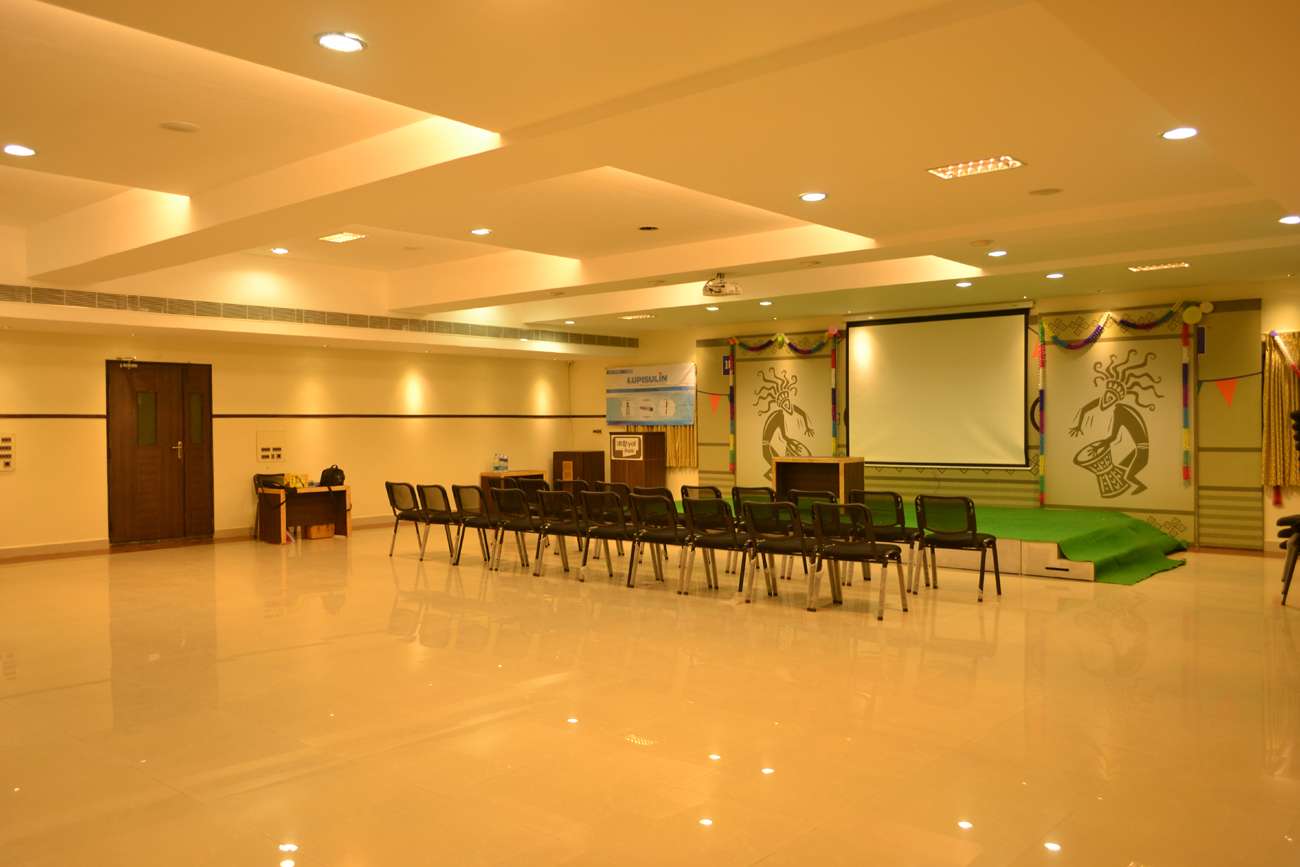 Spacious multi-purpose hall featuring a decorated stage with movable seating arrangement – Designed as a venue for cultural events, seminars, and training sessions— In Salem.