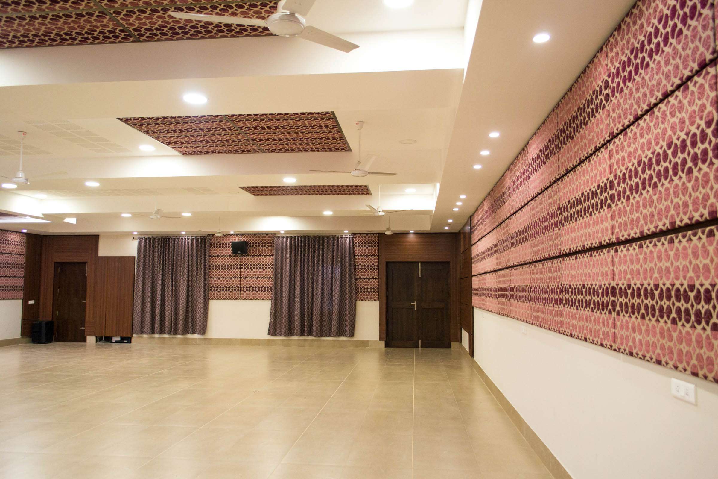 Spacious multi-purpose hall with patterned acoustic wall panels, designed for events, gatherings, and community programs with modern sound insulation—by expert acoustic consultants in Ooty, India.