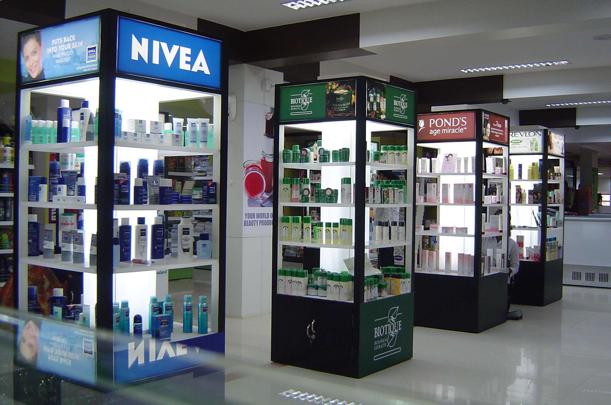 Cosmetic counter interior at a retail store in Chennai, Tamilnadu, featuring illuminated product displays from top skincare brands — perfect for showcasing modern retail products – interior design and cosmetic fixture solutions by interior designers and shopfitting contractors.