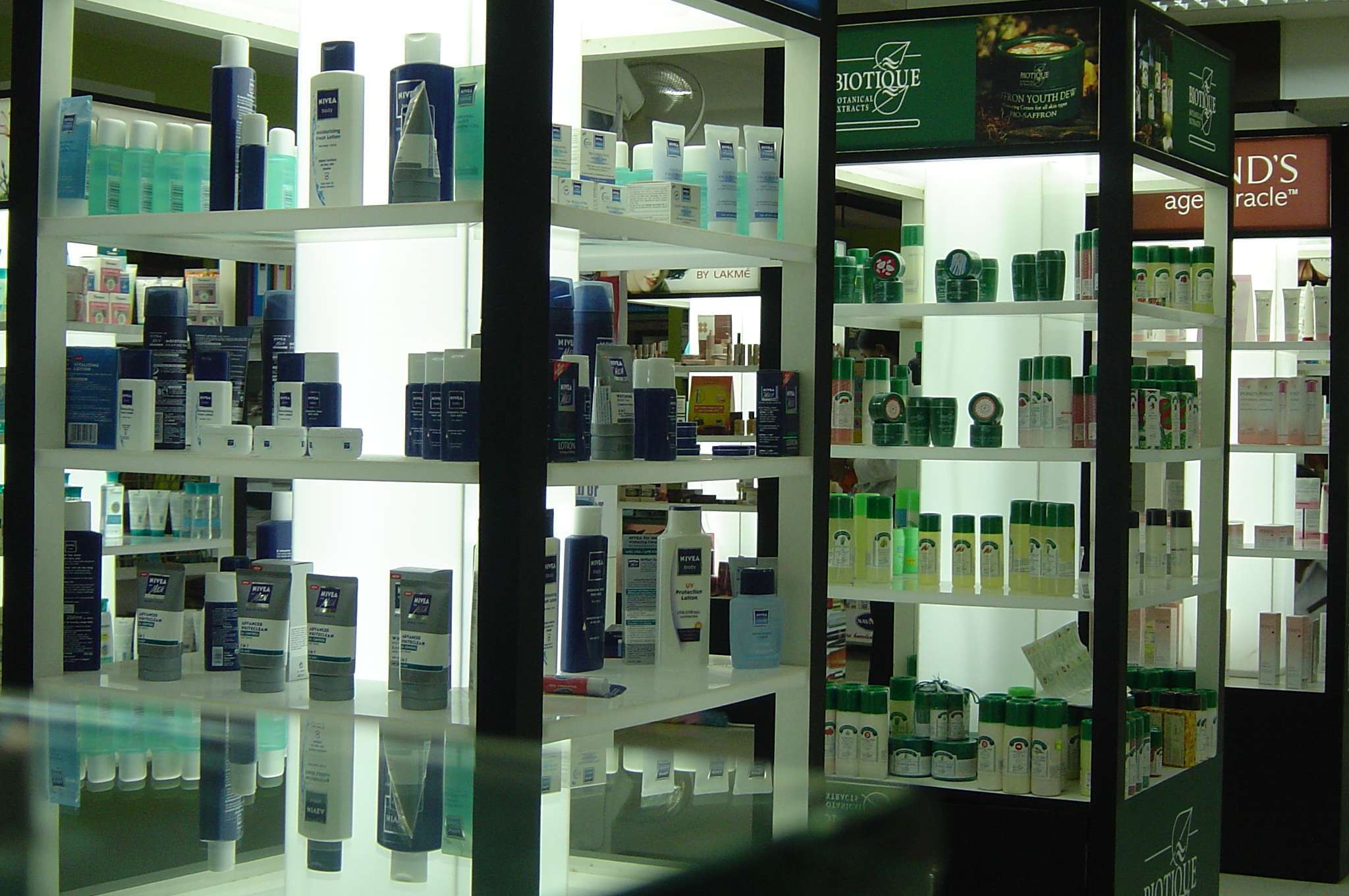 Close-up view of illuminated cosmetic display shelves in a departmental store in Tamilnadu, featuring skincare products — designed, manufactured and supplied by us.