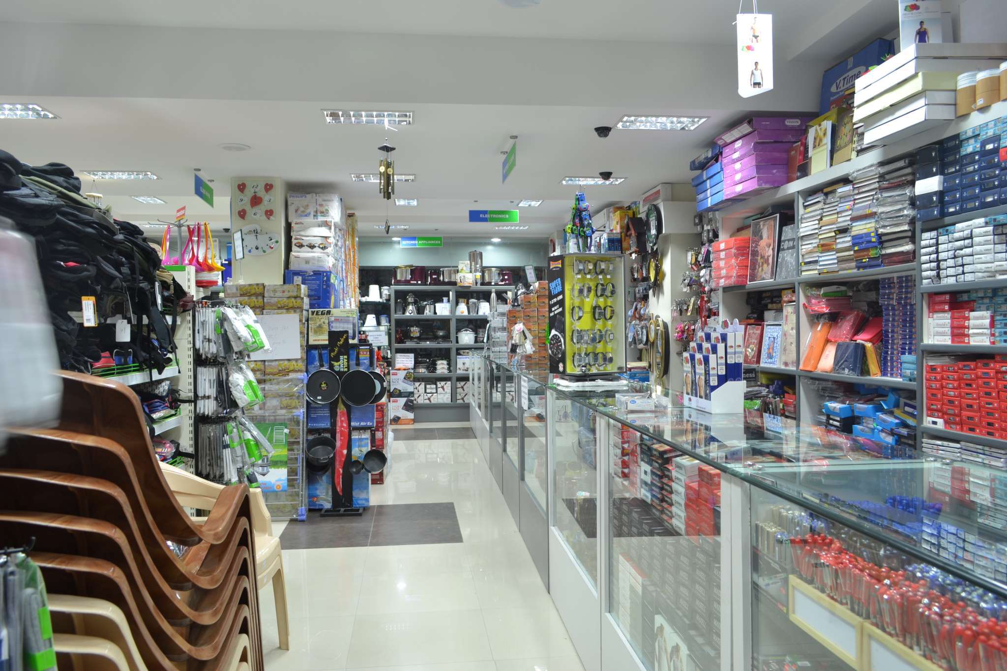 Commercial retail store interior in Erode, Tamilnadu, featuring organized shelving and display counters with a variety of kitchen appliances, stationery, and home essentials — ideal for showcasing retail store interior design and fixture installation by interior designers, manufacturers, and contractors.