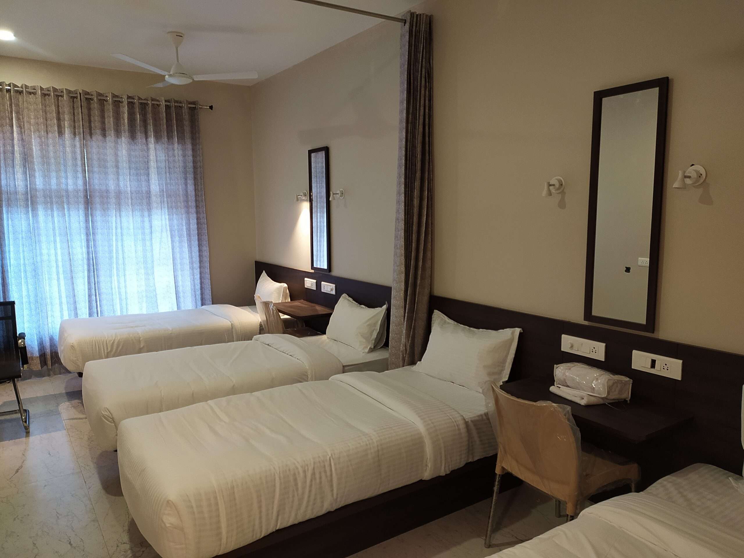 Hotel room, dormitory interior at Tiruppur, Tamilnadu, with minimalist design,— hotel interior designers, furniture suppliers, and hospitality contractors focused on practical and compact room layouts.