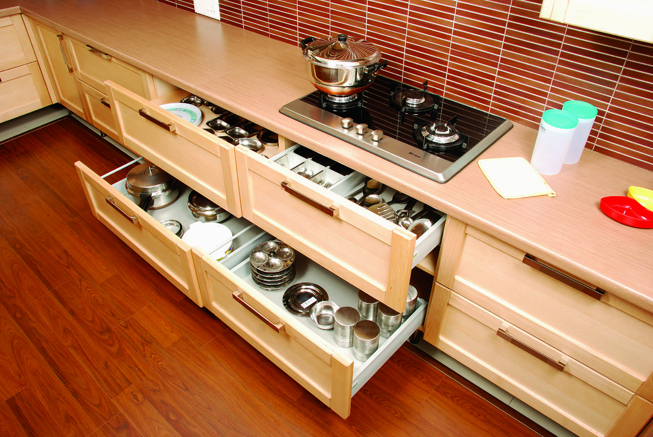 Modular kitchen in Ramanathapuram, Coimbatore featuring soft-closing drawers with caroussel and built-in hob, Fully designed, manufactured, and installed by our expert interior and furniture team.