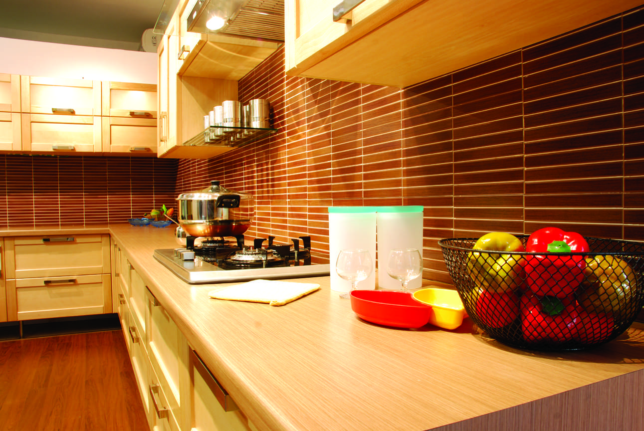 Modular kitchen in Trichy road, Ondipudur, Coimbatore featuring soft-close drawers, gas hob, and organized countertop setup, Fully designed, manufactured, and installed by our expert interior and furniture team.