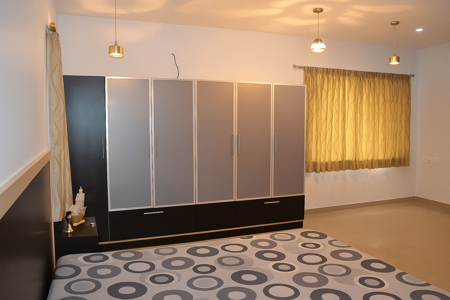Bedroom wardrobe with sleek glossy acrylic shutters in a contemporary setting at a residence in Chennai, Tamil Nadu. Designed, manufactured, and installed by our expert interior and furniture team.