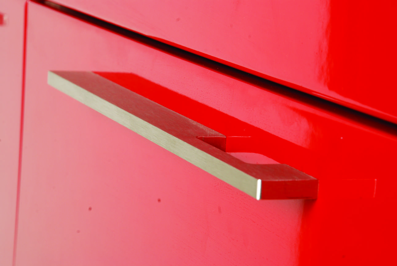 Red modular kitchen shutter at a modern residence in Chennai. Fully designed, manufactured, and installed by our expert interior and furniture team.